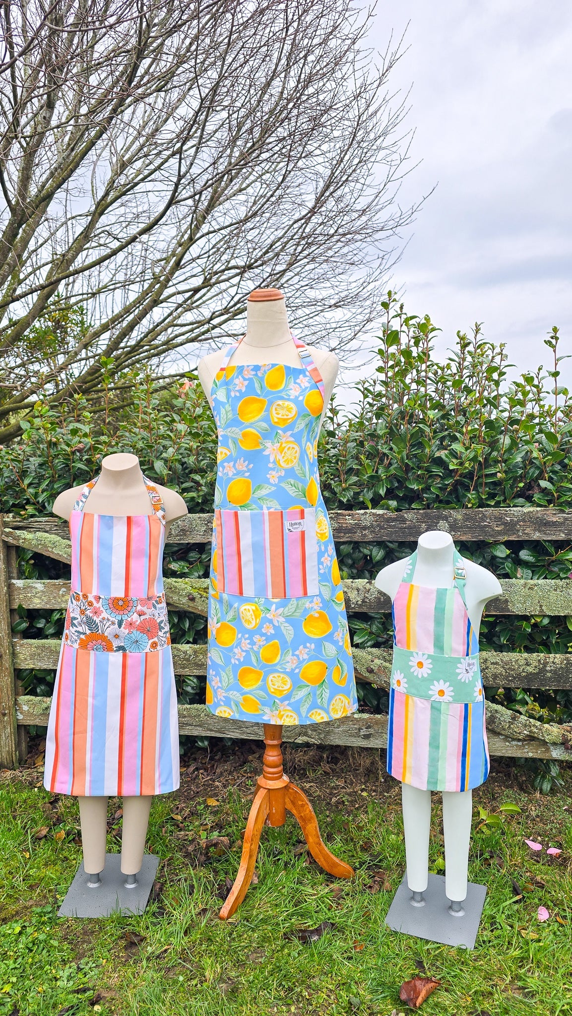 womens bib style apron in navy with mustard daisies